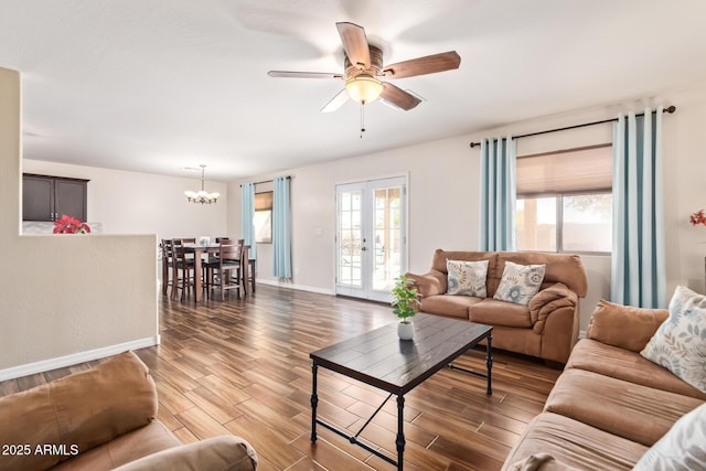 living room featuring french doors, a healthy amount of sunlight, and dark hardwood / wood-style flooring