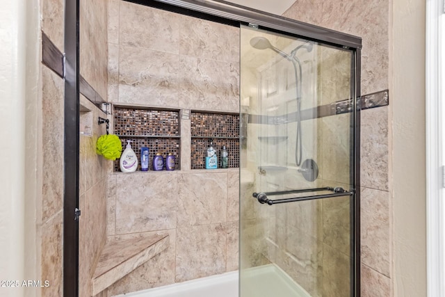 bathroom featuring a shower with shower door