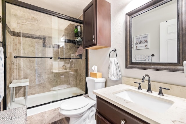 full bathroom featuring shower / bath combination with glass door, vanity, and toilet