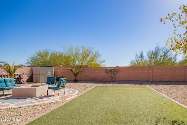 view of yard featuring an outdoor fire pit and a patio area