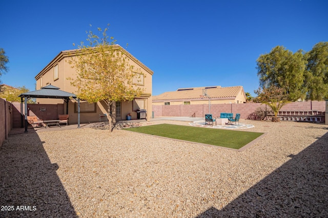 back of property with a gazebo and a patio