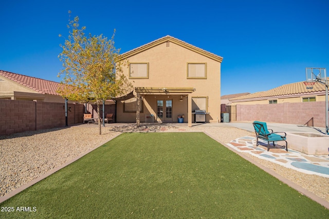 back of house featuring a yard and a patio