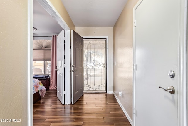 entryway with dark wood-type flooring