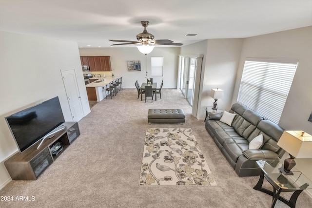 living room with light carpet and ceiling fan