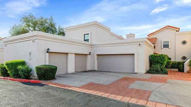 view of side of property with driveway and stucco siding