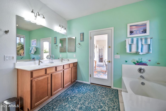 bathroom featuring tile patterned floors, a washtub, and vanity