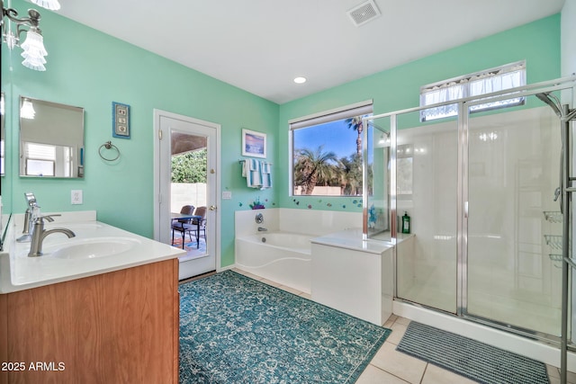 bathroom featuring vanity, a wealth of natural light, and independent shower and bath