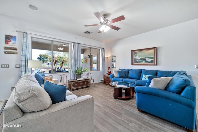 living room with hardwood / wood-style floors and ceiling fan