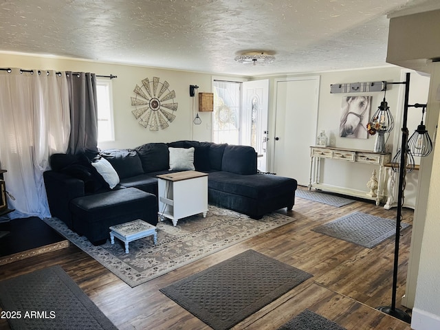 living room with a textured ceiling and wood finished floors