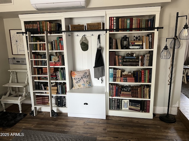 mudroom with wood finished floors, visible vents, and a wall mounted air conditioner