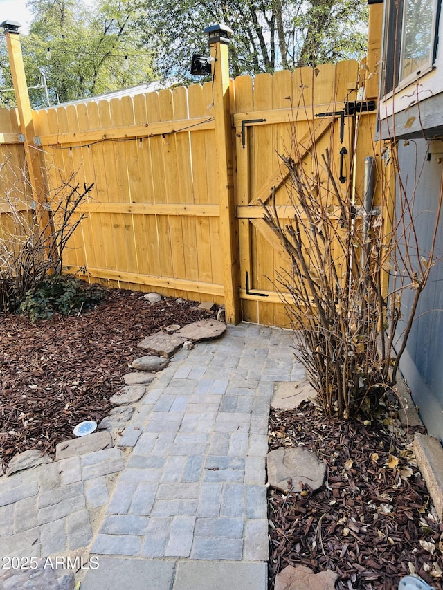 view of patio with a gate and fence