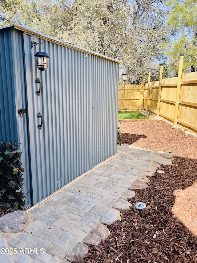 exterior space with an outdoor structure and a fenced backyard