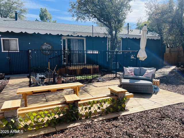 view of patio / terrace with a deck, outdoor lounge area, and fence