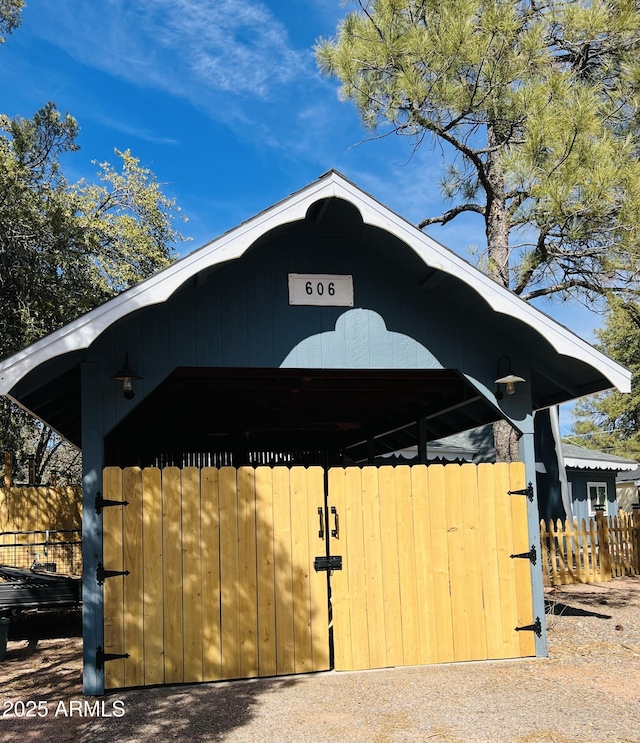 view of outbuilding featuring fence