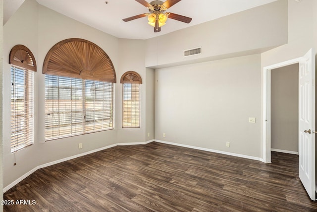 unfurnished room featuring wood finished floors, ceiling fan, baseboards, and vaulted ceiling