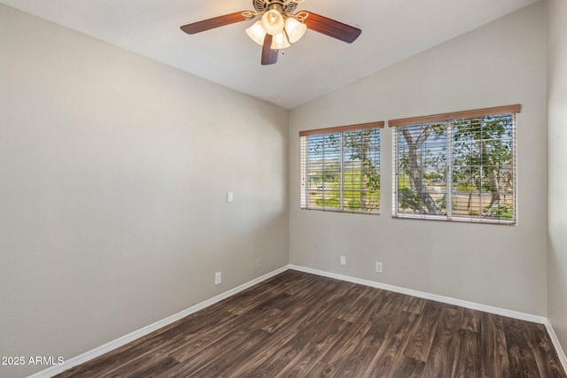 unfurnished room featuring baseboards, dark wood-style flooring, vaulted ceiling, and ceiling fan