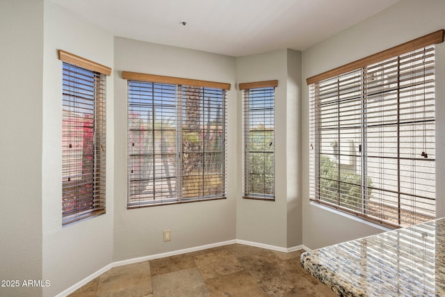 unfurnished dining area with baseboards