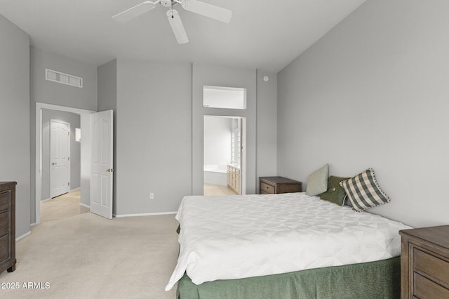 bedroom featuring connected bathroom, light colored carpet, and ceiling fan