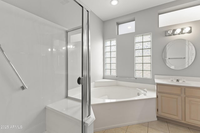 bathroom featuring tile patterned flooring, vanity, and separate shower and tub