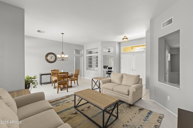 living room with light colored carpet and a chandelier