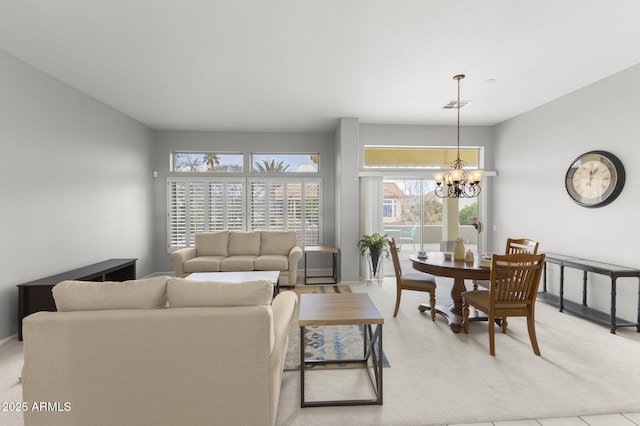 living room featuring light colored carpet and a notable chandelier