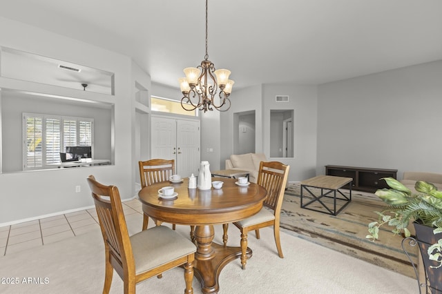 tiled dining area featuring a chandelier