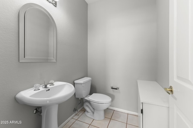 bathroom with tile patterned floors and toilet