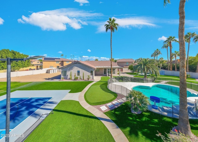 view of swimming pool featuring a yard