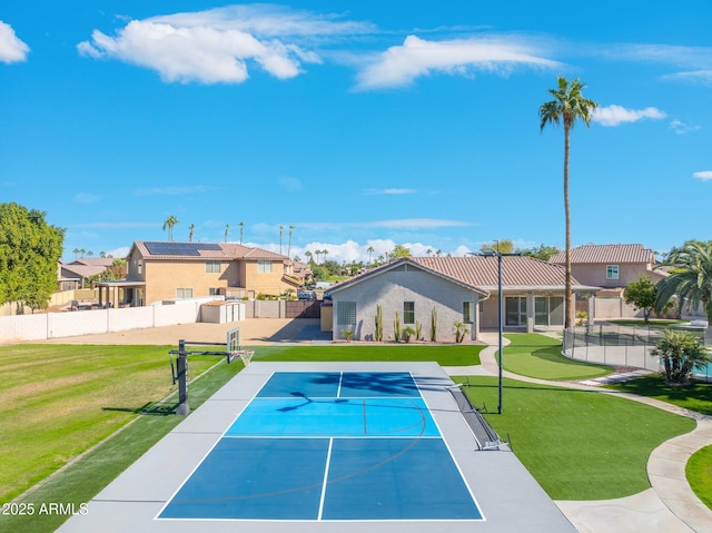 view of pool featuring basketball hoop, a lawn, and tennis court