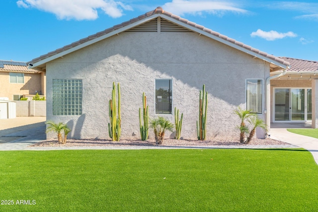 rear view of house featuring a yard