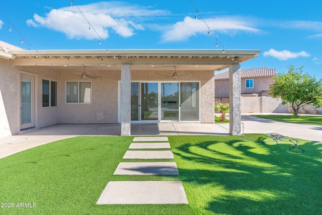 back of house with ceiling fan, a patio, and a lawn