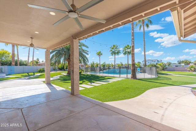 view of patio featuring a pool and ceiling fan