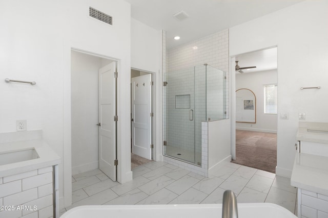 bathroom featuring ceiling fan, vanity, and an enclosed shower