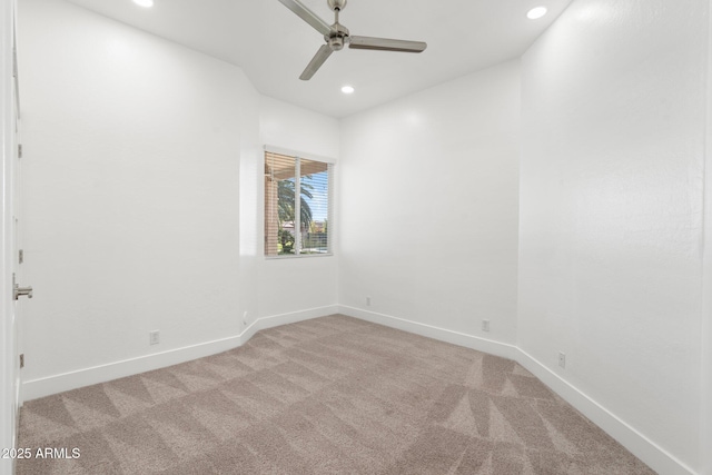 spare room featuring light carpet and ceiling fan