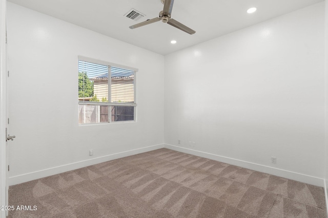 carpeted spare room featuring ceiling fan