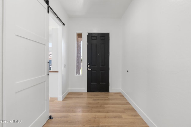 interior space featuring light hardwood / wood-style floors and a barn door