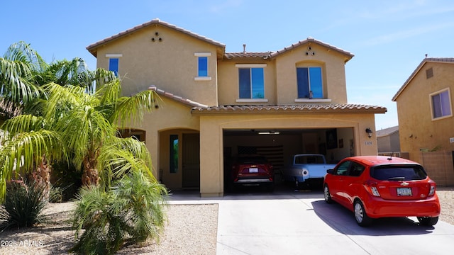 1309 W Park St, Phoenix, AZ 85041 - mediterranean / spanish-style house featuring a tile roof, driveway, stucco siding, and a garage