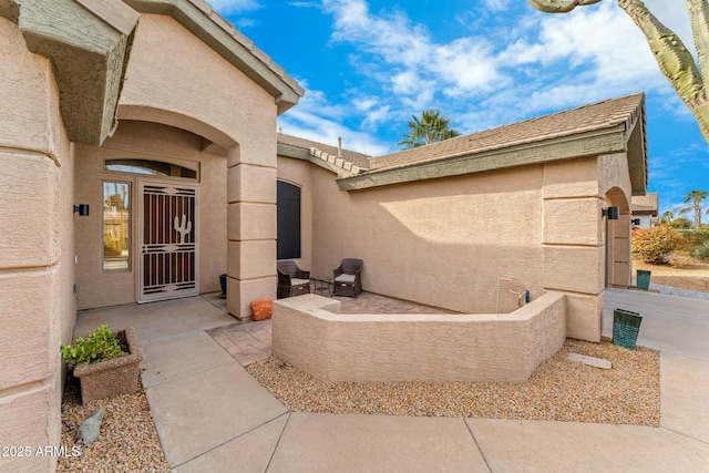 doorway to property featuring a patio area