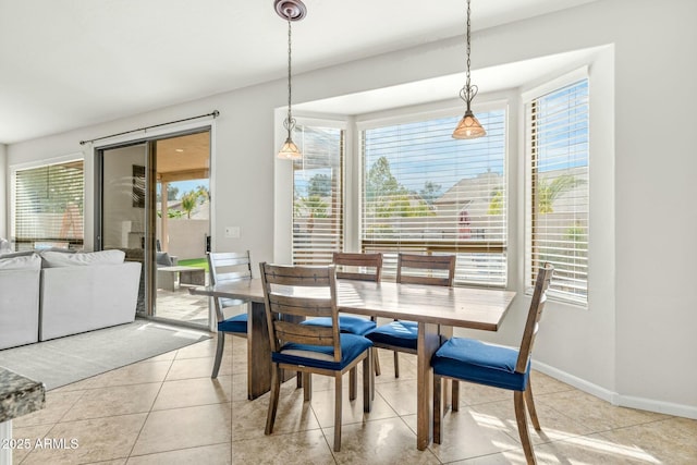 dining area with a wealth of natural light and light tile patterned floors