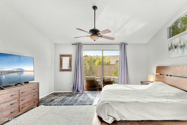 bedroom featuring ceiling fan, access to exterior, and vaulted ceiling