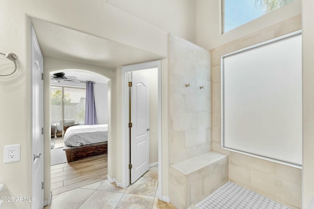 bathroom with ceiling fan and tile patterned flooring