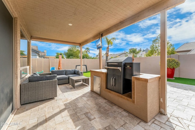 view of patio / terrace featuring an outdoor kitchen, an outdoor hangout area, and a grill