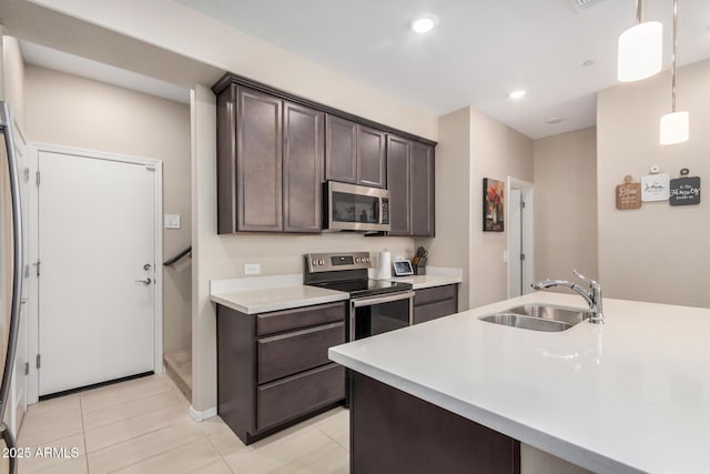 2631 S Sulley Dr Unit 104, Gilbert, AZ 85295 - kitchen with stainless steel appliances, a sink, dark brown cabinets, light countertops, and light tile patterned floors