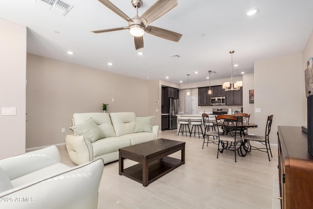 2631 S Sulley Dr Unit 104, Gilbert, AZ 85295 - living room featuring a chandelier, a ceiling fan, recessed lighting, and baseboards