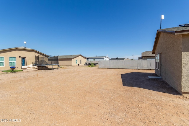 32024 N Redding St, Wittmann, AZ 85361 - view of yard featuring a trampoline and fence