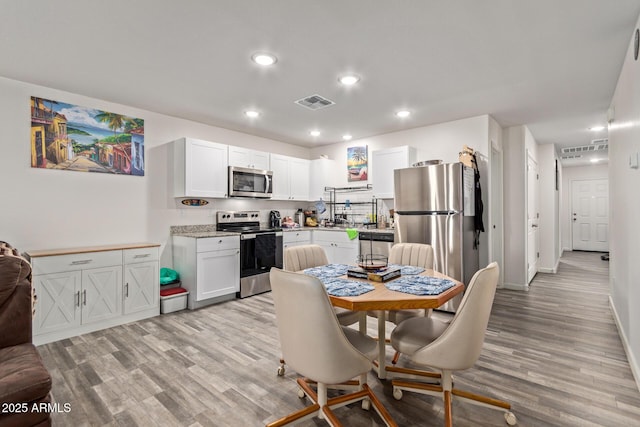 32024 N Redding St, Wittmann, AZ 85361 - dining space with light wood-style floors, baseboards, visible vents, and recessed lighting