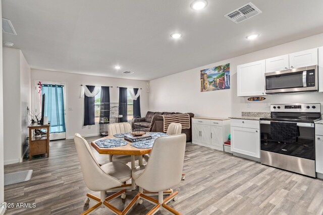 32024 N Redding St, Wittmann, AZ 85361 - dining space featuring light wood-style floors, recessed lighting, and visible vents