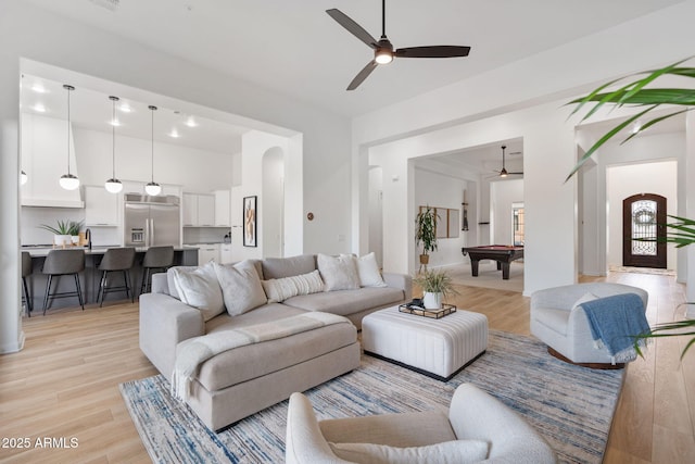 living room featuring ceiling fan, billiards, and light hardwood / wood-style floors