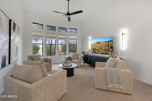 carpeted living room with ceiling fan