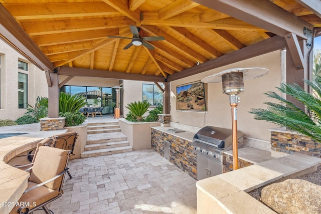 view of patio with a gazebo, area for grilling, exterior kitchen, and ceiling fan